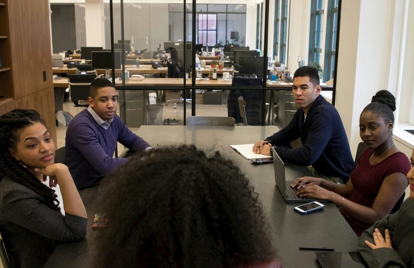 a group of people sitting around a table